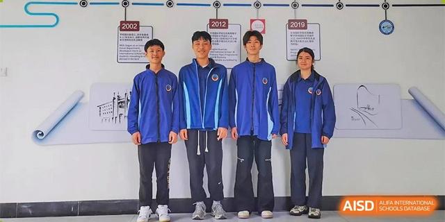 Five students from Ningbo Huamao International School posing together in matching blue tracksuits.