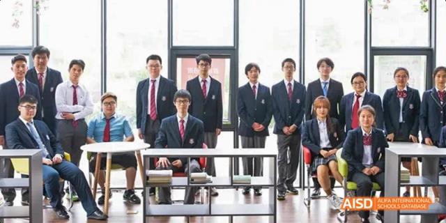 A group of male students and a teacher wearing suits and ties, posing formally for a photo. Beijing No.4 High School International Courses Jialian Campus.