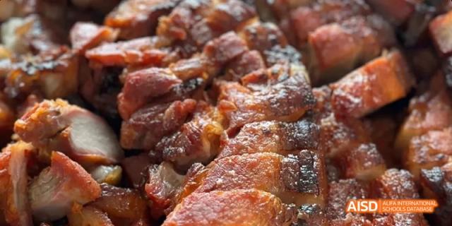 A close-up, appetizing shot of glazed, roasted, or barbecued meat. Beijing No.4 High School International Courses Jialian Campus.