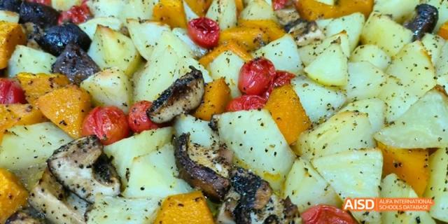 A dish featuring roasted potatoes, dark-skinned vegetables, and cherry tomatoes. Beijing No.4 High School International Courses Jialian Campus.