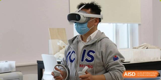 A student wearing a VR headset and mask for a technology lesson at Yew Chung International School of Beijing.