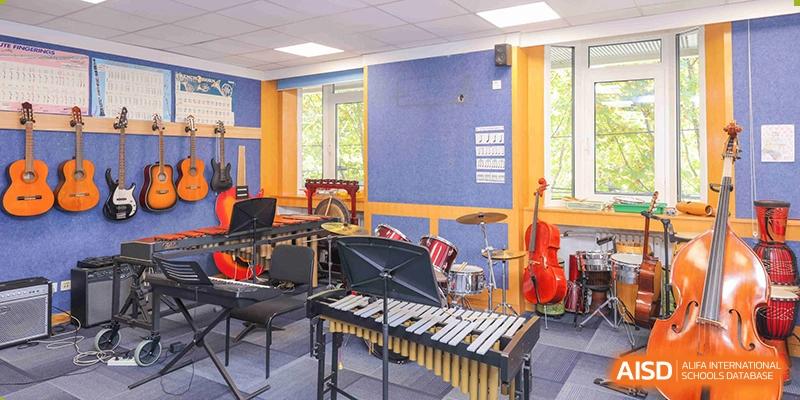 A bright music classroom with a xylophone, drums, and other instruments at Yew Chung International School of Beijing.