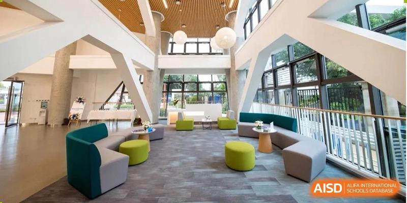 A bright and spacious common area or lobby with modern seating and large windows at Yew Chung International School of Beijing.