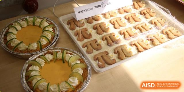 A quiche or tart with zucchini slices and a decorative pattern of mushroom caps on top, served at Yew Chung International School of Beijing.