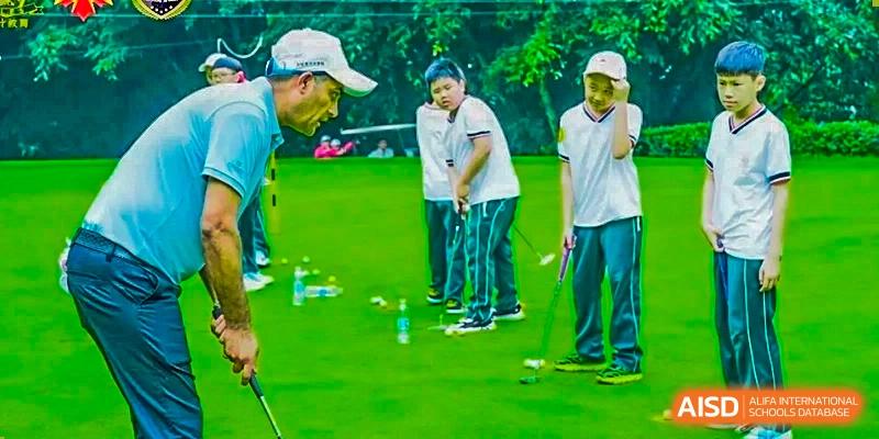 Students receiving instruction while practicing putting on a golf course or training green at Maple Leaf International School Chongqing.