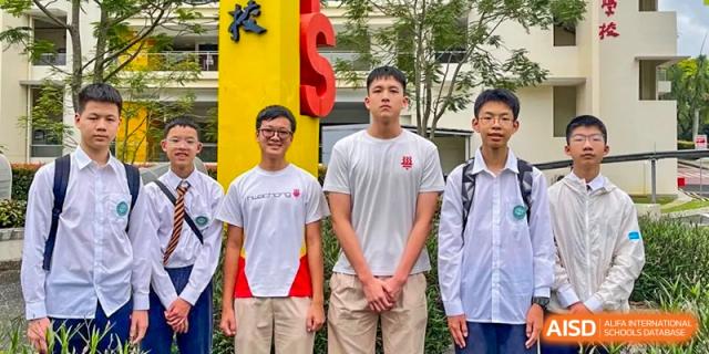 Two tall male students standing together for a photo, possibly a sports team or class picture at Wuxi Big Bridge Academy.