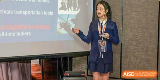A female student from Zhuhai Oriental Yinghua International Academy giving a presentation or speech.