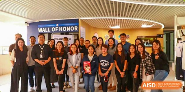 A large group photo of students and staff at Zhuhai Oriental Yinghua International Academy standing together.