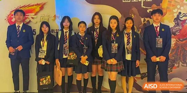 A group of female students from Zhuhai Oriental Yinghua International Academy posing in their school uniforms.