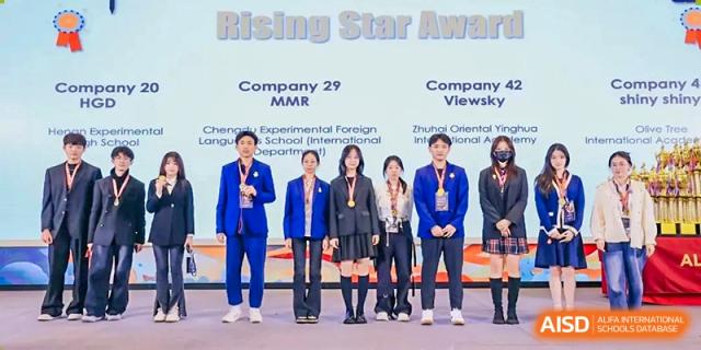 Four students from Zhuhai Oriental Yinghua International Academy and possibly others, standing on a stage at a "Rising Star Award" ceremony.