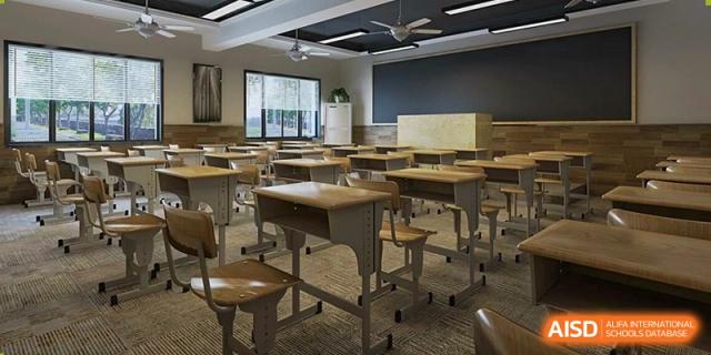 An interior view of an empty, modern classroom with rows of wooden desks and chairs, a ceiling fan, and large windows at Changjun Bilingual School Of Changsha City