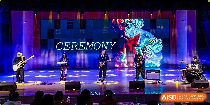 A vibrant stage performance with dramatic lighting during a CEREMONY at Changjun Bilingual School Of Changsha City.