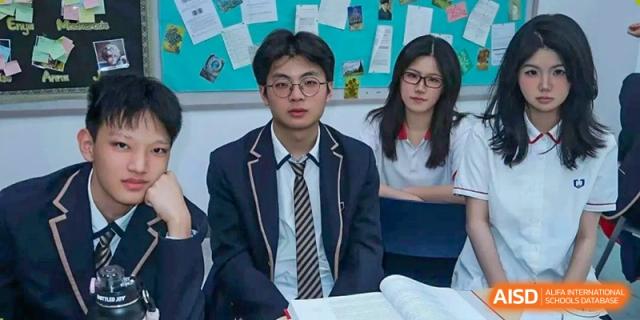 Two students from Cogdel Cranleigh High School in school uniforms (blazer and tie) sitting at a desk and studying.