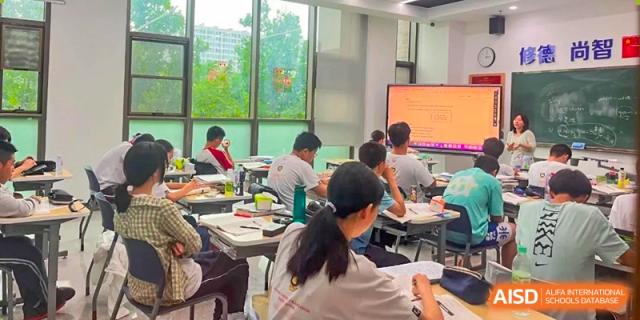 Students from Cogdel Cranleigh High School engaged in a brightly lit classroom, looking toward the front.