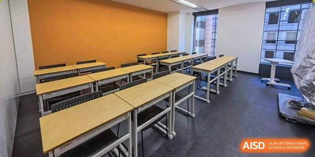 An empty classroom with rows of desks and chairs at Cogdel Cranleigh High School.