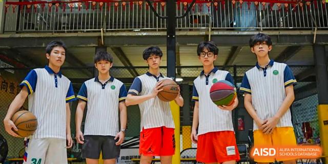 Three male students from Maple Glory Education posing on a basketball court, two holding basketballs.