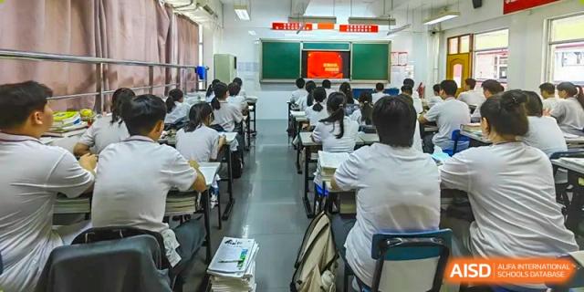 Students seated in a brightly lit classroom, looking toward the front screen during a lecture at Oxstand International School, Shenzhen.