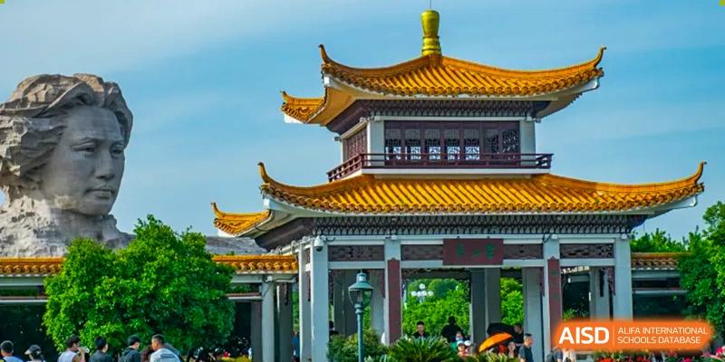 A traditional Chinese pagoda structure with yellow tiled roofs, possibly an entrance or landmark at Oxstand International School, Shenzhen.