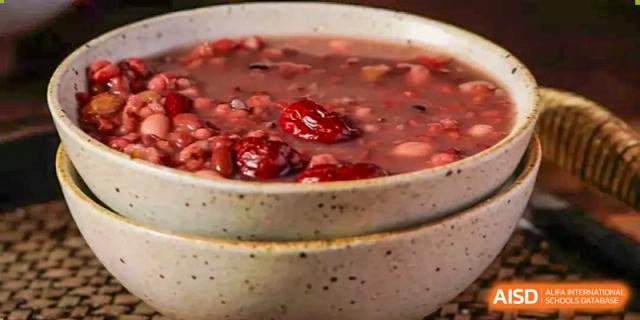 A stack of speckled ceramic bowls containing a sweet red bean and jujube (Chinese red date) soup or dessert served at Oxstand International School, Shenzhen.