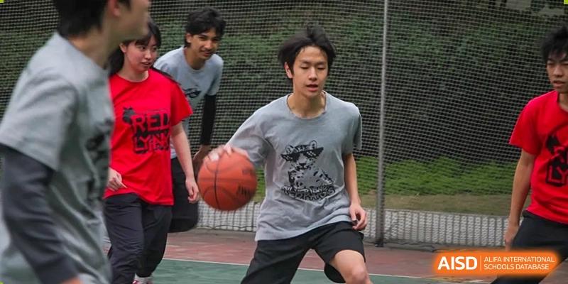 A Shanghai Livingston American School student dribbling a basketball during a game or practice.