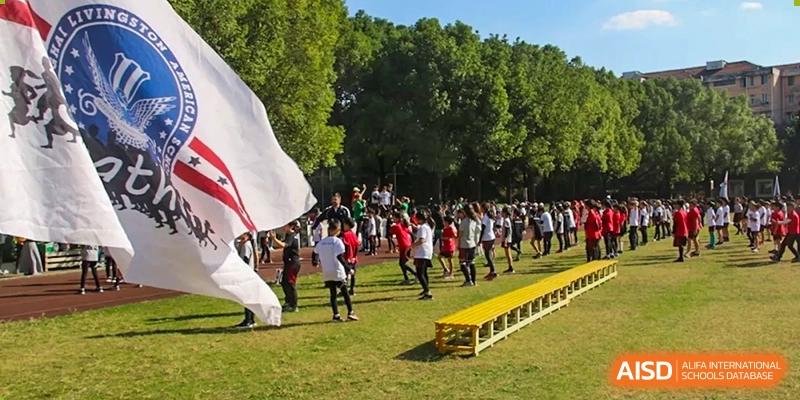 A large group of Shanghai Livingston American School students participating in an outdoor event or parade on a sunny day.