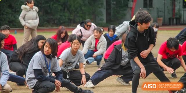 Shanghai Livingston American School students participating in an outdoor physical fitness or health-focused exercise.