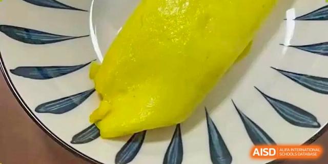 A close-up of a peeled durian fruit segment, indicating the variety of international foods available at Shanghai Livingston American School.