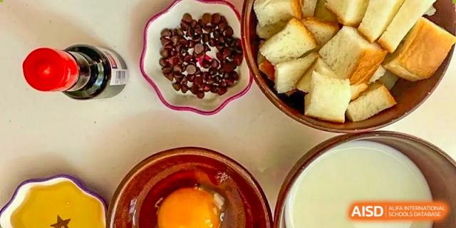 Ingredients for a dish, including red bean paste, pieces of bread, and a raw egg, used in a cooking lesson at Shanghai Livingston American School.