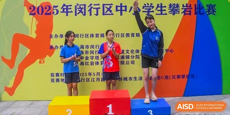 Two female students standing on a winners' podium after a school sports competition, celebrating their victory at Shanghai United International School (SUIS-Jiaoke) Jiaoke Campus.