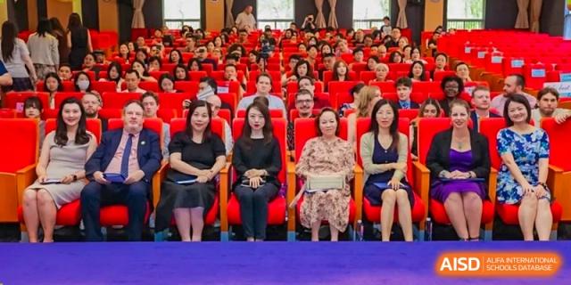 A row of administrators, parents, or judges seated in the audience at an event at Shanghai United International School (SUIS-Jiaoke) Jiaoke Campus.