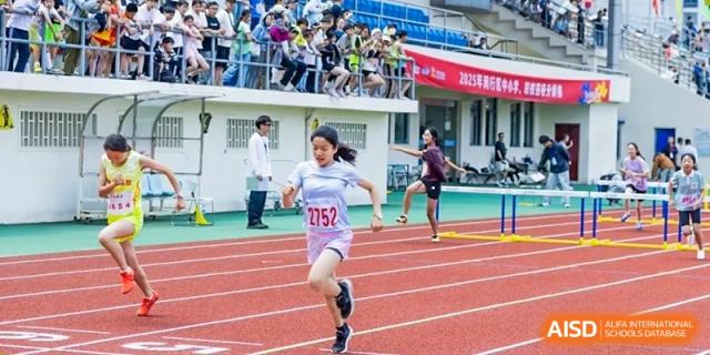 A female student wearing the number 1752 running a race on the track during a sports event at Shanghai United International School (SUIS-Jiaoke) Jiaoke Campus.