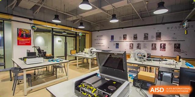 An interior view of a modern science and robotics lab with equipment set up on benches at Yinghua Academy of Tianjin.