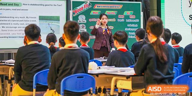 A student presenting or speaking in front of classmates and a teacher in a classroom setting at Suzhou Science and Technology Town Foreign Language High School.