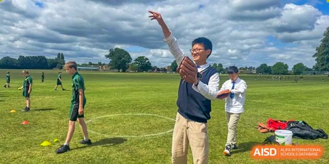 A student throwing a ball outdoors on a sunny sports field during an activity at Suzhou Science and Technology Town Foreign Language High School.