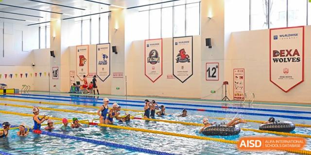 Students at Dehong Beijing International Chinese School participating in a group activity or lesson in the school's indoor swimming pool.