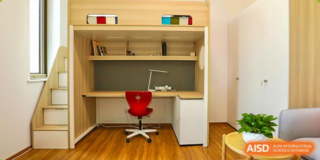 A well-equipped student study area or dorm room setup at Dehong Beijing International Chinese School with a comfortable desk chair.