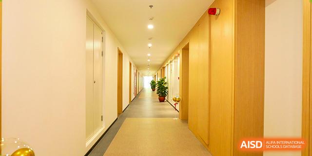 A long, well-lit hallway in the residence or academic building at Dehong Beijing International International Chinese School.