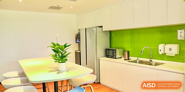 A clean, modern kitchen and dining area at Dehong Beijing International Chinese School, possibly in the student residence.