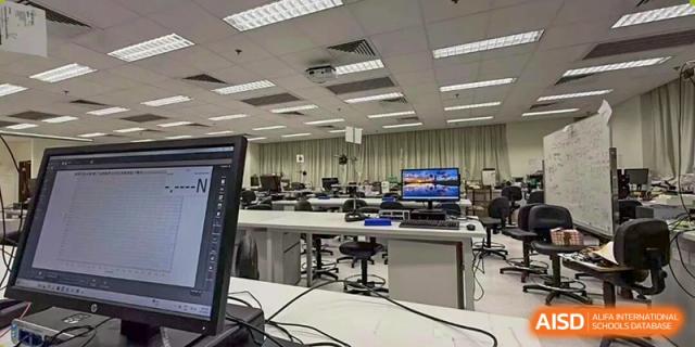 A wide view of a clean, well-equipped computer laboratory with rows of monitors ready for student use at Zhongshan Sanxin School International Department.