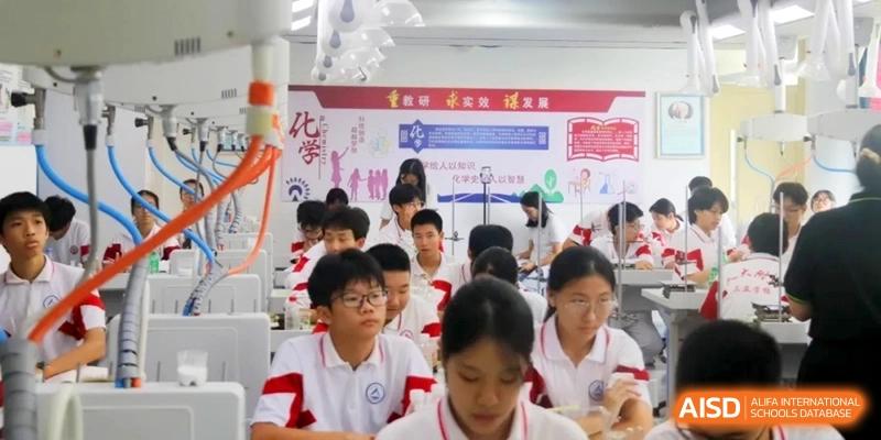 Students sit at their desks in a classroom with educational posters on the walls while engaging in an interactive learning activity at RDFZ Sanya School