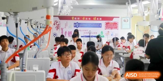 Students sit at their desks in a classroom with educational posters on the walls while engaging in an interactive learning activity at RDFZ Sanya School