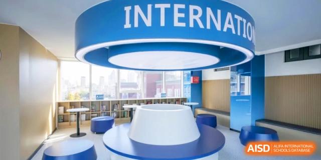 A modern, blue and white internal library or lounge area provides a study space at the Attached Senior School Of Shandong Normal University.