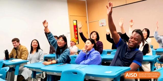 Enthusiastic students raise their hands to participate in a lively classroom discussion at the Attached Senior School Of Shandong Normal University.