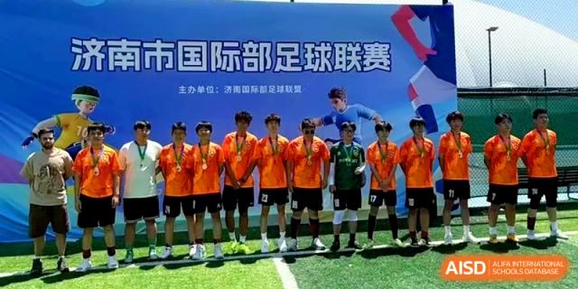 The school football team stands together wearing medals after a successful sports tournament at the Attached Senior School Of Shandong Normal University.