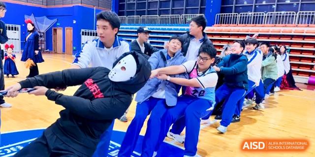 Students participate in a fun tug-of-war competition during a sports day event at the Attached Senior School Of Shandong Normal University.