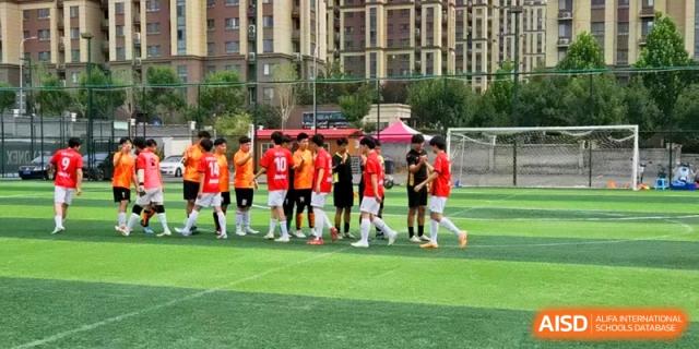 Young athletes in sports uniforms shake hands and show sportsmanship after a football game at the Attached Senior School Of Shandong Normal University.
