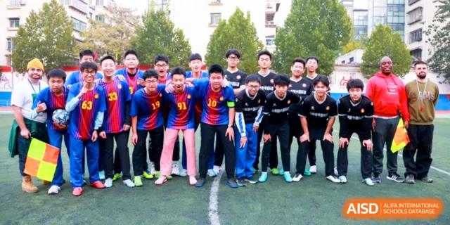 Student athletes in sports gear gather on the green turf for a team photograph at the Attached Senior School Of Shandong Normal University.