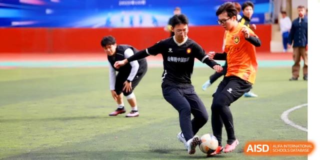 Soccer players compete for the ball during an intense match on the school grounds at the Attached Senior School Of Shandong Normal University.