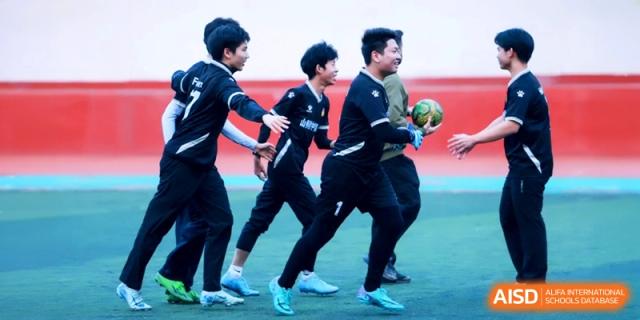 Teammates celebrate together on the field after a successful sports play at the Attached Senior School Of Shandong Normal University.