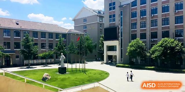 An aerial view of the lush school courtyard and modern architectural buildings at Tianjin Foreign Languages School.